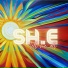 SH.E